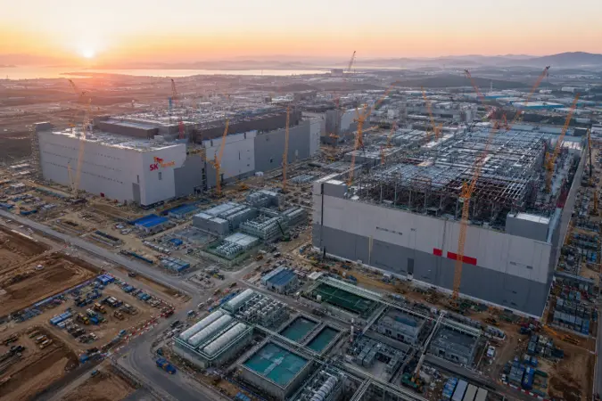 Aerial editorial rendering of semiconductor fab construction in South Korea with SK hynix branding.