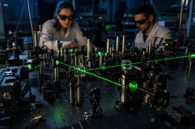 An optical quantum physics laboratory with a laser beam passing through lenses, mirrors and beam splitters on an optical table.